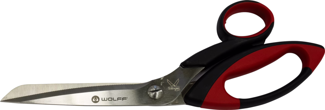 A pair of large stainless steel scissors with a serrated cutting edge, black and red ergonomic plastic handles, and the 'WOLFF' logo printed on the blade. The blades are riveted and slightly angled; the handle includes a soft-grip insert for comfort. Photographed on a white background.