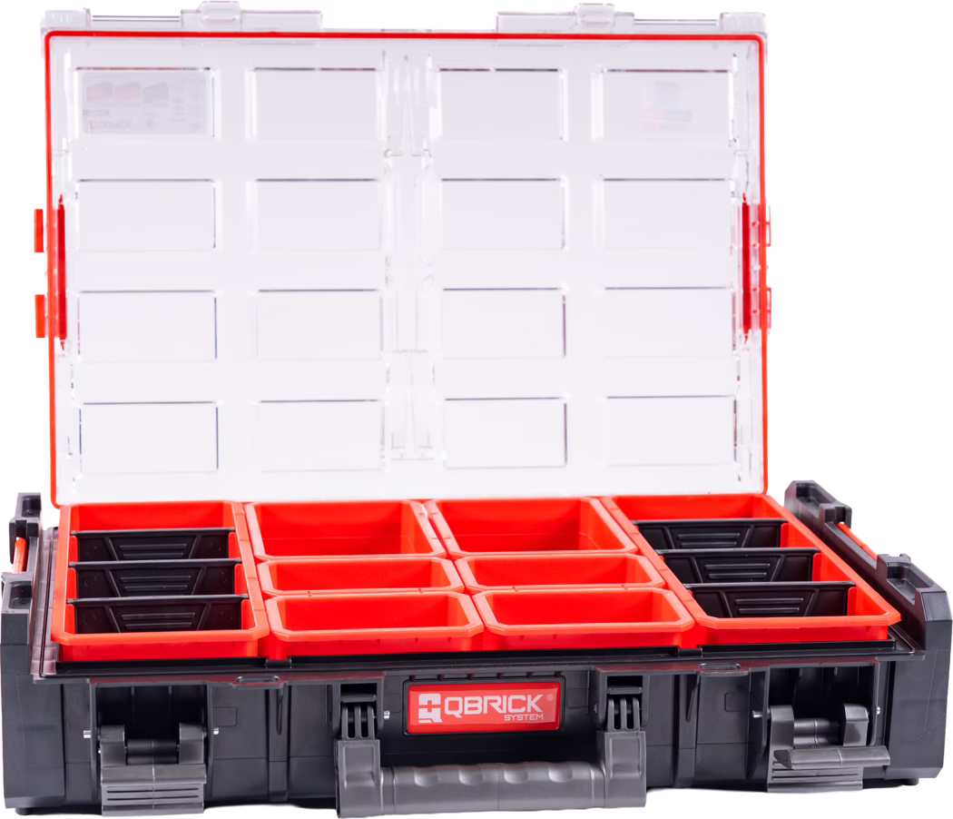 Open plastic organizer box with a transparent hinged lid and multiple empty removable red and black bins arranged in rows. The clear lid has molded rectangular pockets and snap closures; the front of the black base shows the 'QBRICK SYSTEM' logo. The interior displays neatly aligned small-parts trays suitable for screws, nuts and small tools. Photo taken from the front with the lid open against a white background and bright lighting; materials are hard plastic with a strong color contrast between the red bins and the black case.