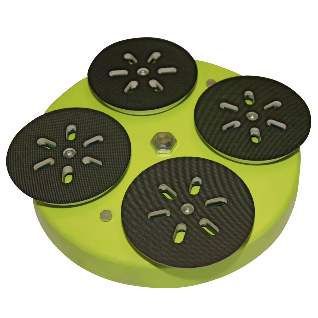 Close-up top view of a circular lime-green multi-pad tool with five black round sanding or polishing pads arranged in a flower-like pattern on a white background. Each pad features cut-out slots and a textured rubber surface; visible metal screws, bolts and a central nut secure the pads to the green metal base. The image emphasizes the pad texture, the slotted openings and the contrast between the black pad faces and the bright green painted metal body.