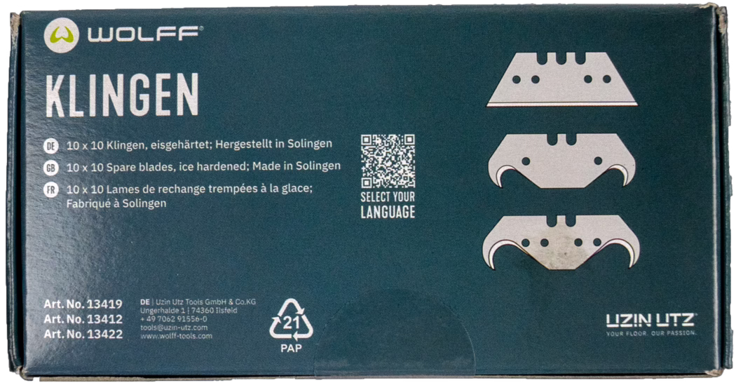 WOLFF_Dummy_13419_13421_blade box_2025-08 Dark teal-blue rectangular cardboard box of the WOLFF brand with a large white title 'KLINGEN' on the left and three stylized blade illustrations on the right showing different hook shapes. The package lists multilingual product information in German, English and French stating '10 x 10 spare blades, ice hardened; Made in Solingen' and features a small QR code with the text 'SELECT YOUR LANGUAGE'. Lower-left printing shows article numbers (Art. No. 13419, 13412, 13422) and manufacturer contact details for Uzin Utz. A recyclable 'PAP 21' symbol and the UZIN UTZ logo with the slogan 'YOUR FLOOR. OUR PASSION.' are visible. The box corners show minor wear and one blade illustration has slight discoloration; overall the packaging appears intact and ready for retail.